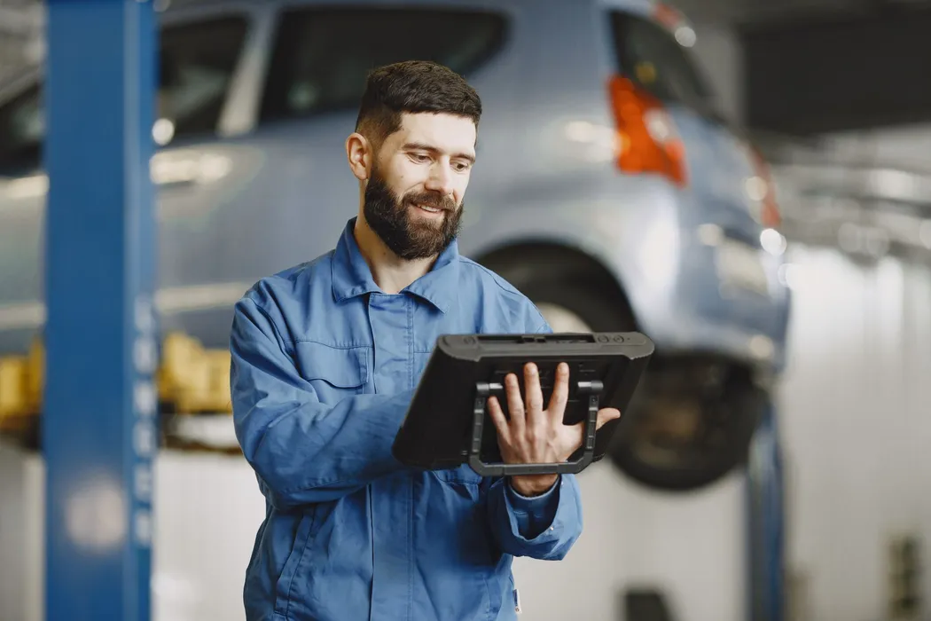 Field service technician reviewing a digital service report after job completion