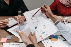 Compliance professional reviewing business documents and audit notes in an office