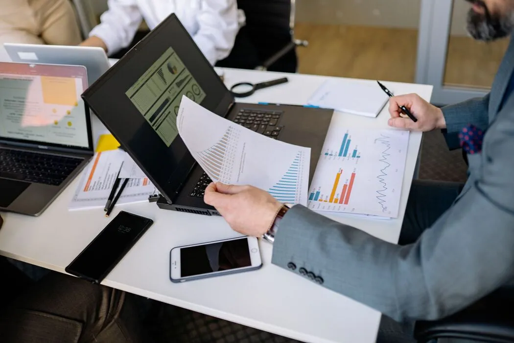 Professionals analysing charts and dashboard metrics during an operations meeting