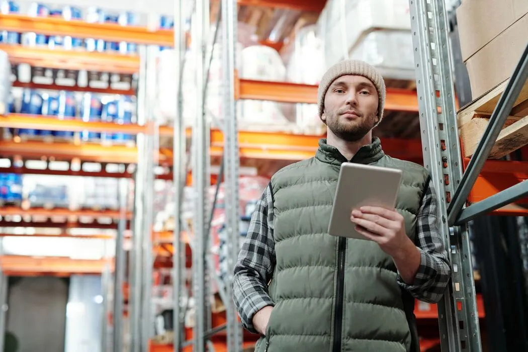 Warehouse manager using a tablet to monitor operational activity